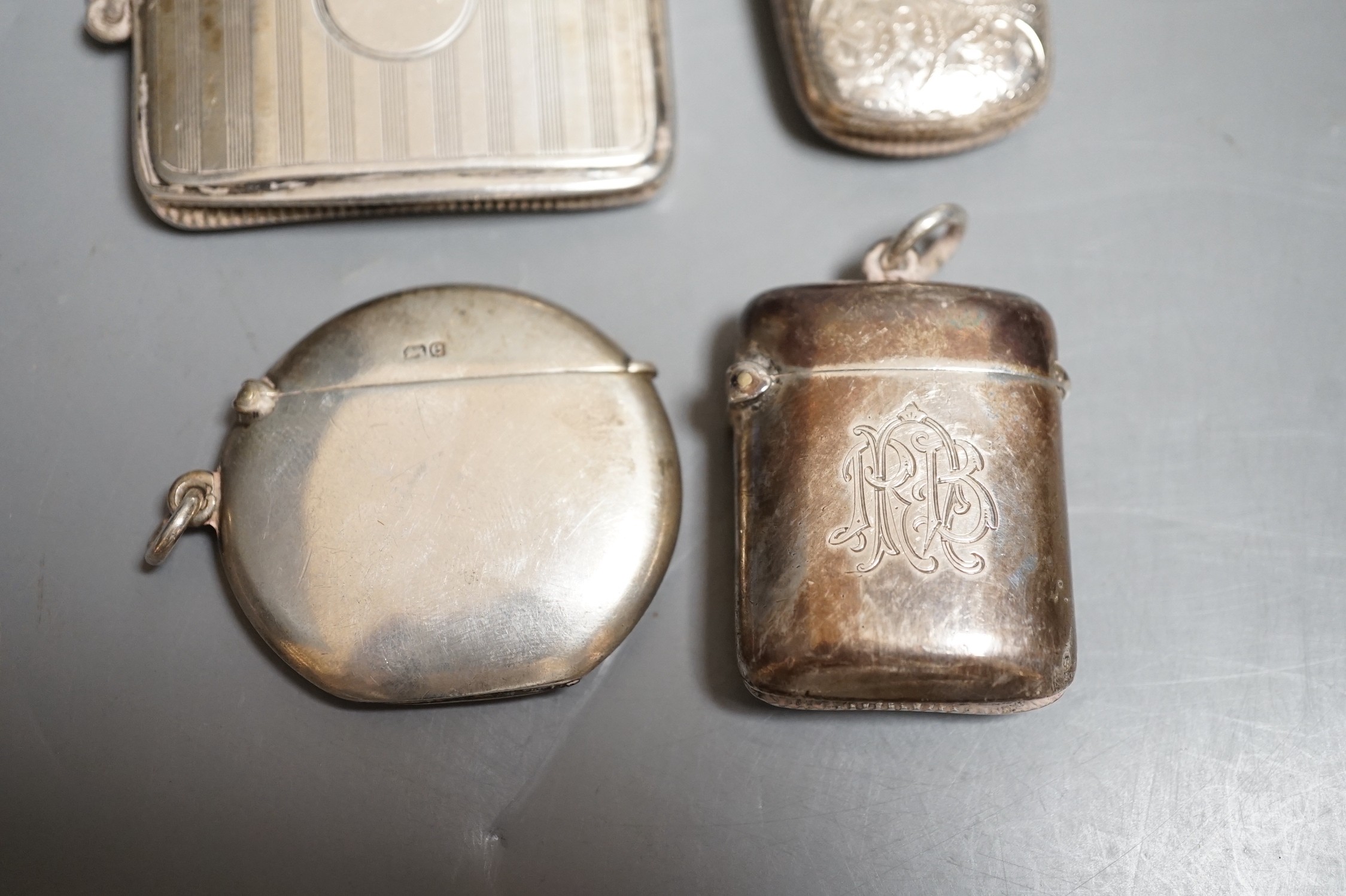 Four assorted late 19th/early 20th century silver vesta cases, including circular, 42mm.